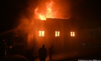 Massive fire destroys commercial property and damages adjoining homes