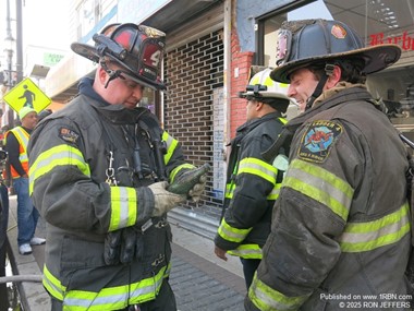 North Hudson FF Troy Joseph inspects old Coke bottle