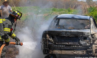 Yaphank car fire extends to brush
