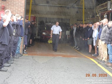 Assistant Fire Chief David Roach walk out