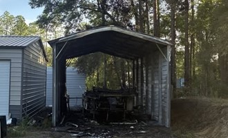RV Fire Destroys Camper and Carport, Crews Stop Spread to Nearby Brush