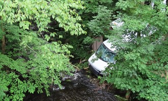Sparrowbush Engine Co. and mutual aid extricate entrapped motorist near edge of stream