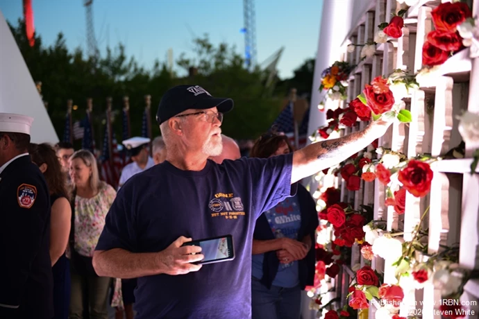 A guest puts a rose on their loved ones profile.
