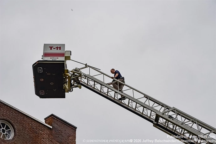 Fire investigator going to take pictures of the roof of the fire building
