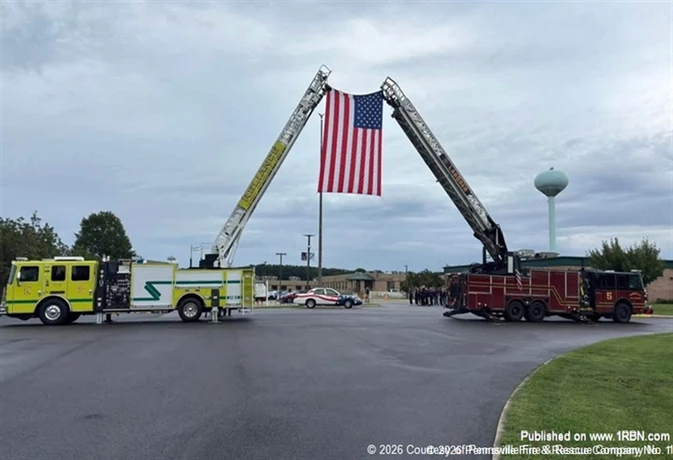 Pennsville Fire & Rescue Company No. 1 Ladder 5 and Reliance Fire Company Ladder 12 raise a large American flag during a September 11 memorial service at Salem County Vo-Tech. Fire and EMS personnel gathered to mark the 25th anniversary and honor the firefighters, police officers, EMS personnel and civilians who lost their lives in the attacks.