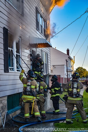Firefighters Venting The Front Windows As Crews Make A Push On The 1st & 2nd Floor