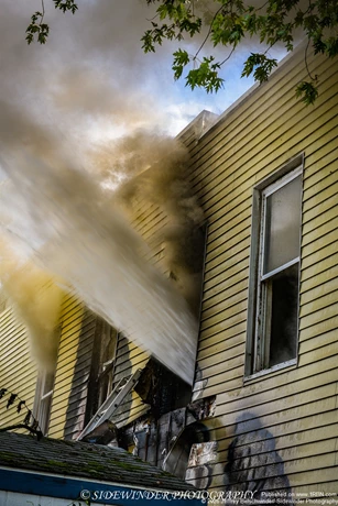 Firefighters on the second Floor Conducting Hydraulic Ventilation  