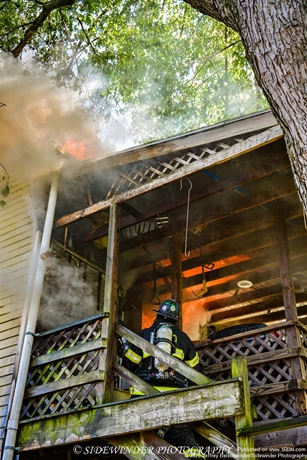 Heavy Fire Rolling Over The Firefighters on The Second Floor