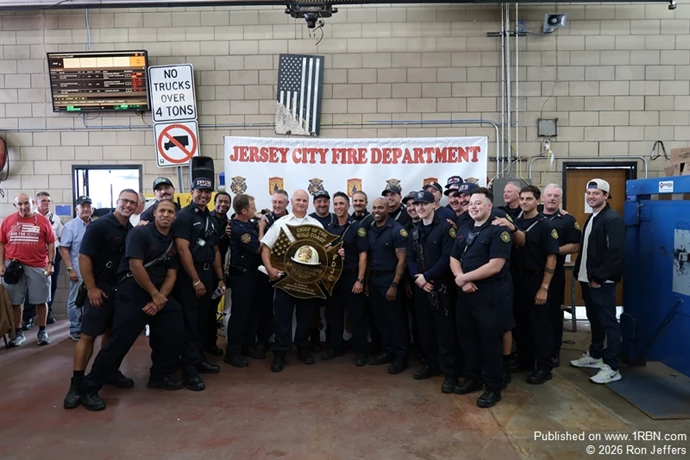 Jersey City First Battalion Chief Sean Verdi, center, received praise and many gifts at his firehouse retirement lunch, after 34-years of service, September 30th.