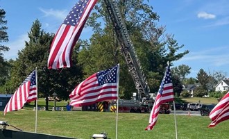 Tribute Wall Ceremony Highlighted by Patriotic Flag Display