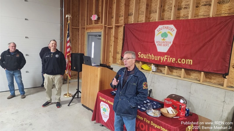 JD McAulay Accepts Dedication To New Rescue 1. Chief Hamila and Lyman Gilbert look on. 