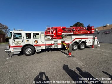 Franklin Park Firefighters Review New East Brunswick Ladder Truck
