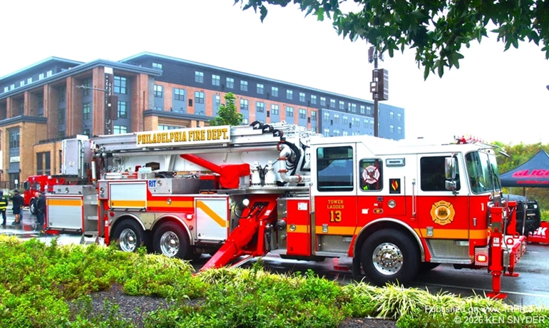 Philadelphia Fire Department Tower Ladder 113 is displayed with its stabilizers deployed during the 2026 Philadelphia Fire Muster along Delaware Avenue.