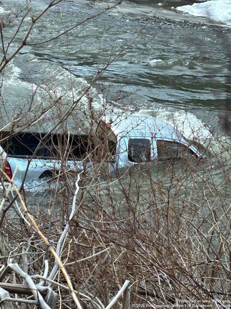 Vehicle Rolls into Ottauquechee River; Driver Escapes Injury