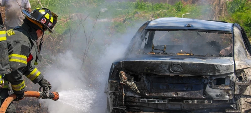 Yaphank car fire extends to brush